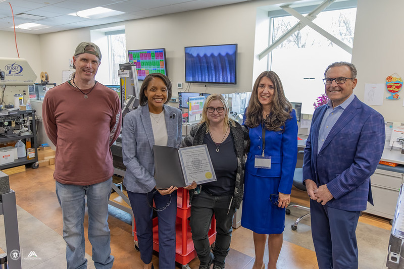 Secretary Jones presents Nicole Sousa, Quality Control Technician, with her Certificate of Completion in the Apprenticeship Program.