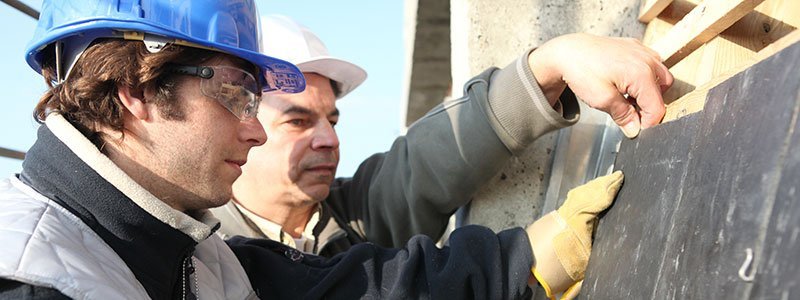 two construction workers working